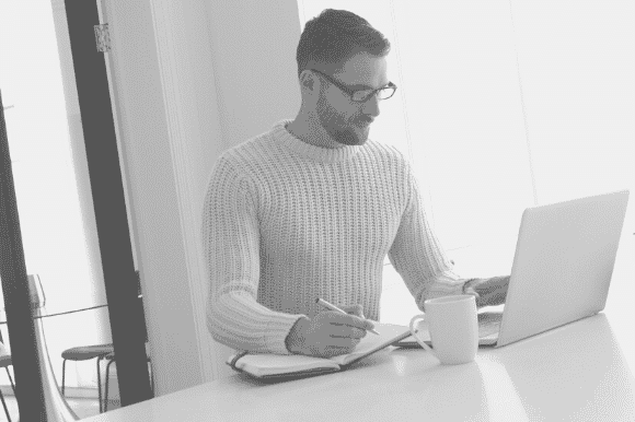 Recruiter sitting down and writing an effective job advert.
