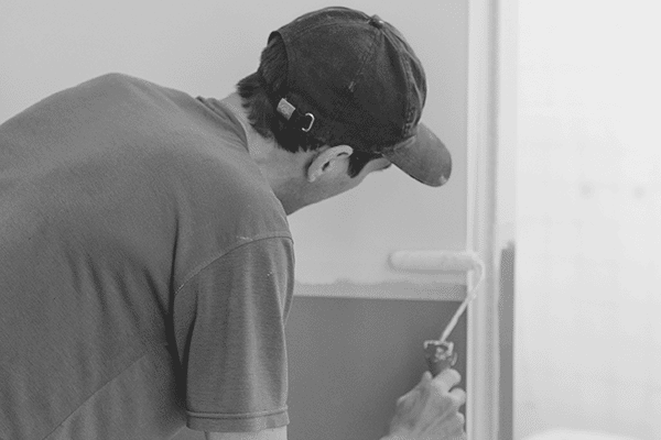 Painter decorating a wall