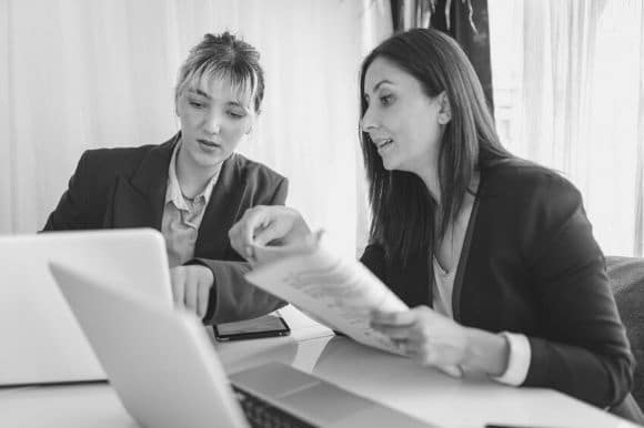 Managing director meeting with a colleague, discussing the terms of a contract.