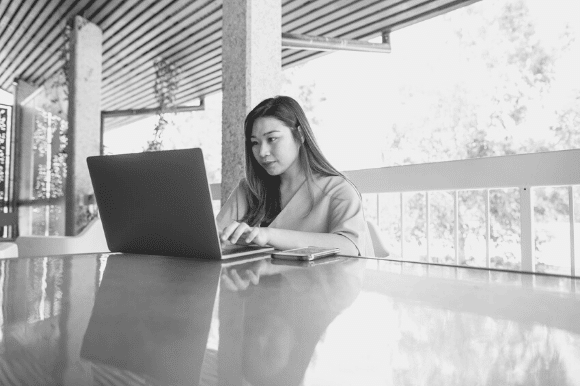 Woman on her computer responding to a request from a bad worker looking for a job reference.