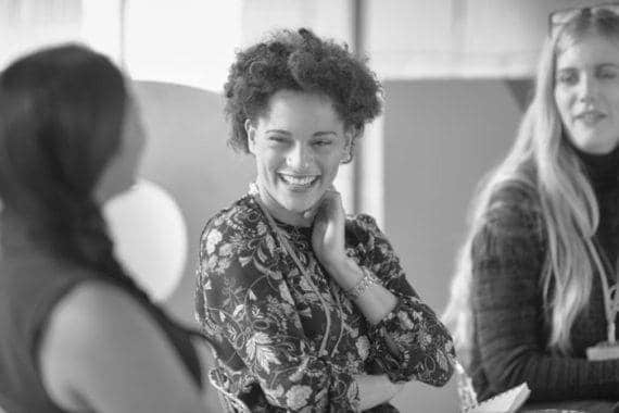 A smiling employee, no doubt happy because she's at a great place to work.